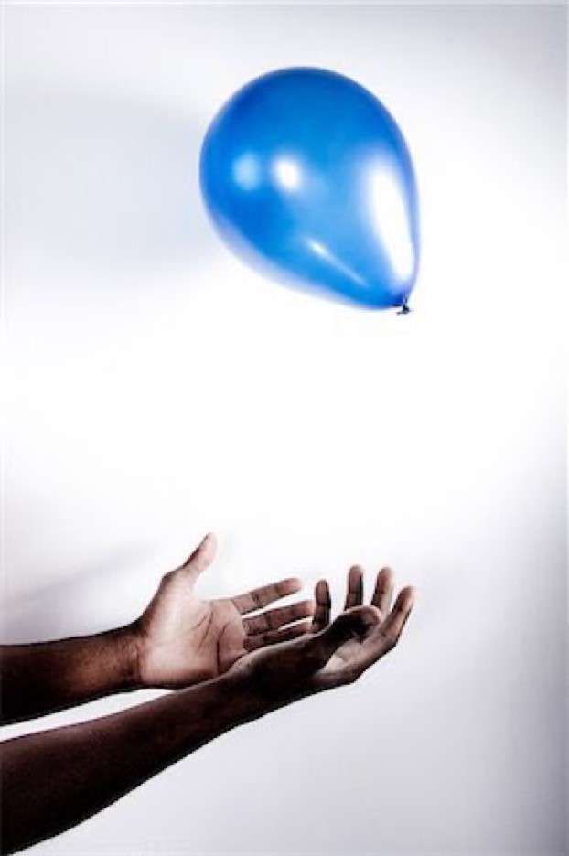 Hands catching a balloon